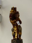 A JAVANESE FIGURE OF A DEMON WARRIOR MOUNTED WITH KRIS WITH WAVY DAMASCENE BLADE CONTIANED IN WOOD