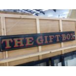 A HAND PAINTED SIGN THE GIFT BOX.