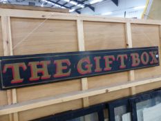 A HAND PAINTED SIGN THE GIFT BOX.