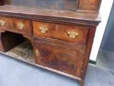 AN 18th.C.OAK AND ELM LARGE DRESSER WITH THREE DRAWERS OVER TWO PANELLED DOORS AND WITH ASSOCIATED