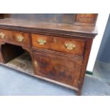 AN 18th.C.OAK AND ELM LARGE DRESSER WITH THREE DRAWERS OVER TWO PANELLED DOORS AND WITH ASSOCIATED