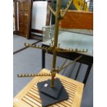AN ART DECO BRONZE AND ALLOY SHOP DISPLAY STAND WITH ADJUSTABLE ARMS.