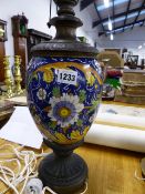 AN ANTIQUE MAJOLICA BALUSTER VASE WITH BRONZE MOUNTS FITTED AS A LAMP. OVERALL H.52cms.