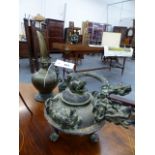 AN ORIENTAL CAST BRONZE KETTLE WITH A DRAGON SPOUT TOGETHER WITH AN EASTERN BRASS OIL EWER.