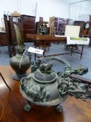 AN ORIENTAL CAST BRONZE KETTLE WITH A DRAGON SPOUT TOGETHER WITH AN EASTERN BRASS OIL EWER.