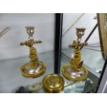 A PAIR OF VICTORIAN SILVERED AND GILT METAL CANDLESTICKS OF ANCHOR FORM H.18cms TOGETHER WITH A