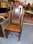 AN 18th.C.AND LATER OAK PANEL BACK HALL CHAIR.