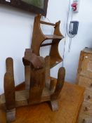 AN ERCOL WALL SHELF AND A MID CENTURY HARDWOOD NEWSPAPER STAND.