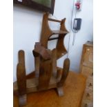 AN ERCOL WALL SHELF AND A MID CENTURY HARDWOOD NEWSPAPER STAND.