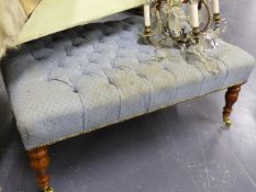 A LARGE BUTTON UPHOLSTERED FOOTSTOOL ON TURNED LEGS. L.105 x W.69cms.