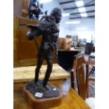 A BRONZE FIGURE OF A COWBOY CARRYING A SADDLE, A SIGNED LIMITED EDITION MODERN CAST ON CONFORMING