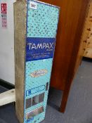 A VINTAGE TAMPAX VENDING MACHINE.