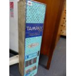 A VINTAGE TAMPAX VENDING MACHINE.