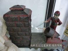 A VINTAGE CAST IRON MECHANICAL MONEY BOX.