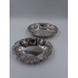 TWO VICTORIAN SILVER HALLMARKED BONBON DISHES WITH A REPOUSSE SCROLL WORK AND PIERCED DESIGN.