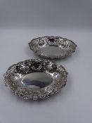 TWO VICTORIAN SILVER HALLMARKED BONBON DISHES WITH A REPOUSSE SCROLL WORK AND PIERCED DESIGN.