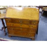 A LATE 18th.C.OAK BUREAU WITH THREE SHORT AND THREE LONG DRAWERS ON BRACKET FEET. W.92 x H.101cms.