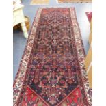 A PERSIAN HAMADAN RUNNER. 390 x 140cms.