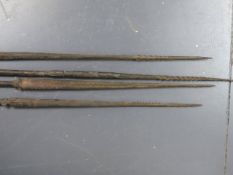 A GROUP OF FOUR ANTIQUE TRIBAL FISHING SPEARS WITH CARVED DECORATION, PROBABLY OCEANIC