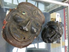 A BENIN BRONZE MASK TOGETHER WITH ANOTHER AFRICAN HAMMERED IRON MASK. (2)