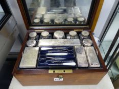 A BRASS INLAID ROSEWOOD VICTORIAN DRESSER BOX WITH SILVERED FITTINGS AND VARIOUS BOXES AND BOTTLES.