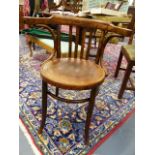 AN EARLY 20th.C.BENTWOOD ARMCHAIR TOGETHER WITH AND OAK FRAMED LONG STOOL WITH DROP IN SEAT PAD.