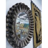 A CONTEMPORARY PAIR OF METAL FRAMED OVAL MIRRORS.