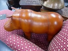 AN UPHOLSTERED LEATHER HIPPO FORM FOOTSTOOL IN THE MANNER OF LIBERTYS.