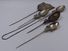FOUR WHITE METAL DECORATIVE ELONGATED SPOONS TOGETHER WITH A SHIELD SHAPED PLAQUE. APPROXIMATE MEASU