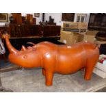A LARGE LEATHER RHINO FORM FOOTSTOOL IN THE MANNER OF LIBERTY'S.