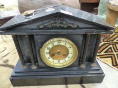 A VICTORIAN BLACK SLATE CASED STRIKING MANTLE CLOCK.