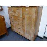 A RARE AMBROSE HEAL DESIGN LIMED OAK SIDE CABINET WITH ARRANGEMENT OF TWO SMALL DOORS OVER FOUR