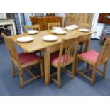 A HEAL'S PALE OAK EXTENDING DINING TABLE TOGETHER WITH A SET OF SIX SIMILAR HEAL'S OAK DINING