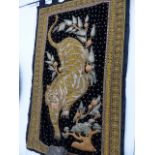 AN EASTERN EMBROIDERED WALL HANGING OF A TIGER. 172 x 104cms.