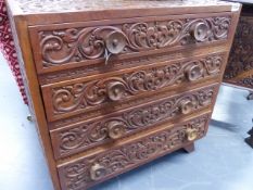 A COLONIAL CARVED TEAK FOUR DRAWER CUTLERY CABINET. W.60cms.