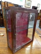 A SMALL MAHOGANY GLAZED TABLE CABINET.