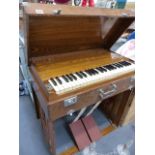 A GOOD QUALITY OAK CASED PORTABLE HARMONIUM PEARL RIVER , COLLAPSES INTO SELF CONTAINED CARRY CASE.