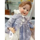A LARGE GERMAN BISQUE HEAD DOLL STAMPED 914 GERMANY.