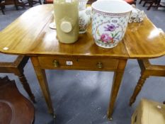 A REGENCY MAHOGANY AND CROSSBANDED PEMBROKE TABLE ON INLAID SQUARE TAPERED LEGS AND BRASS CASTERS.