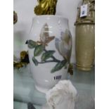 A DANISH B & G MAGNOLIA DECORATED BALUSTER VASE, H.24cms AND A BISQUE MODEL OF A ROSE. (2)