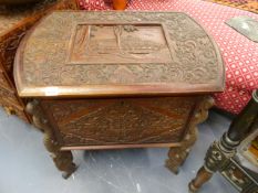 AN ORIENTAL CARVED HARDWOOD LIFT TOP BOX RAISED ON SERPENT FORM LEGS, THE TOP CARVED WITH WALLED