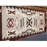 AN AMERICAN NAVAJO INDIAN FLATWEAVE RUG. 185 x 93CMS.