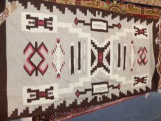 AN AMERICAN NAVAJO INDIAN FLATWEAVE RUG. 185 x 93CMS.