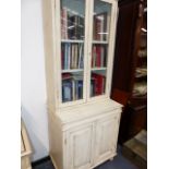 AN ANTIQUE PAINTED PINE GLAZED BOOKCASE ON CABINET. W.86x H.226cms.