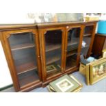 AN ANTIQUE MAHOGANY BREAKFRONT DWARF BOOKCASE WITH FOUR GLAZED PANEL DOORS. W.214 x H.129cms.