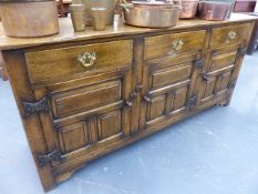 A GOOD QUALITY 18th.C.STYLE OAK DRESSER BASE WITH THREE DRAWERS OVER THREE PANELLED DOORS. W.