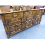 A GOOD QUALITY 18th.C.STYLE OAK DRESSER BASE WITH THREE DRAWERS OVER THREE PANELLED DOORS. W.