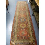 FOUR ANTIQUE PERSIAN RUGS, A HERIZ RUG. 180 x 136cms. A HAMADAN RUNNER. 388 x 100cm AND TWO