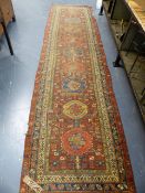 FOUR ANTIQUE PERSIAN RUGS, A HERIZ RUG. 180 x 136cms. A HAMADAN RUNNER. 388 x 100cm AND TWO