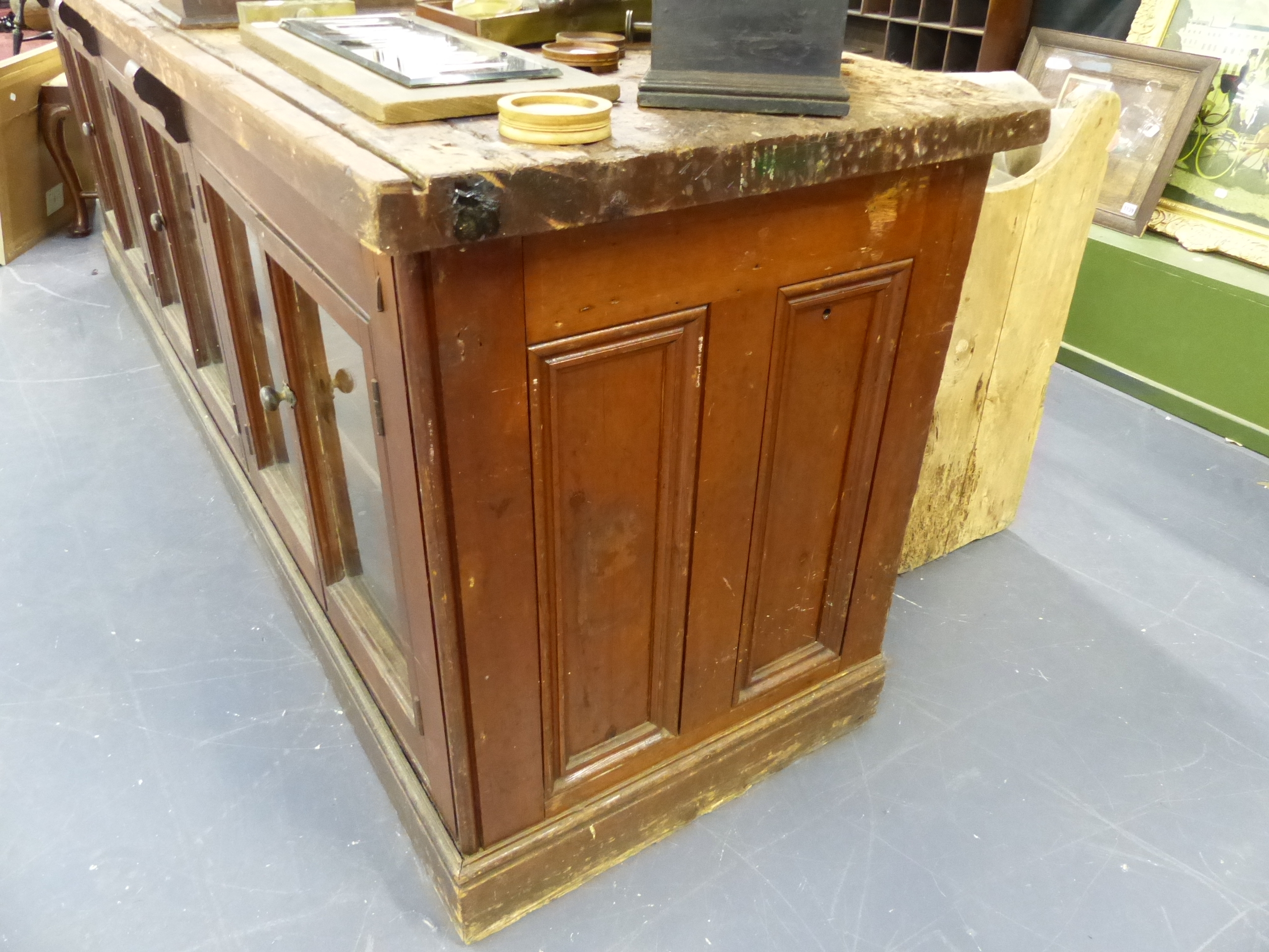 AN ANTIQUE PINE SHOP COUNTER WITH SIX GLAZED PANEL DOORS ENCLOSING SHELVES. W.244 x D.68 x H.83cms. - Image 7 of 16